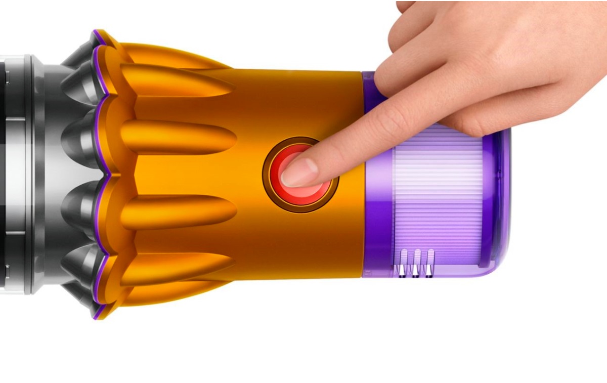 A finger pressing the single power control button.